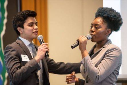 Two students speaking at a competition